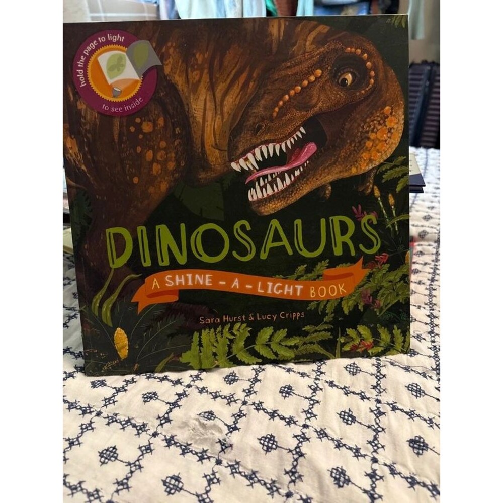 Dinosaurs: A Shine-A-Light Book written by Sara Hurst and Lucy Cripps